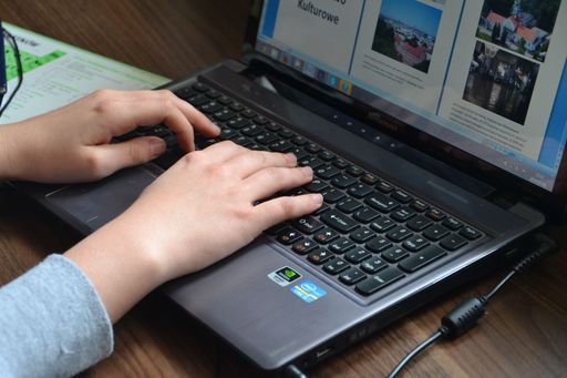 A closeup of a person's hands working on the computer