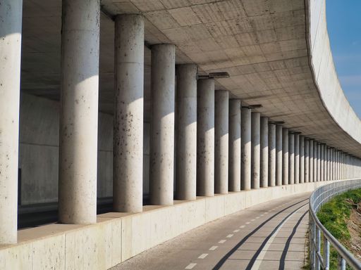 A beautiful shot of the design and columns of a big concrete bridge under sunny day