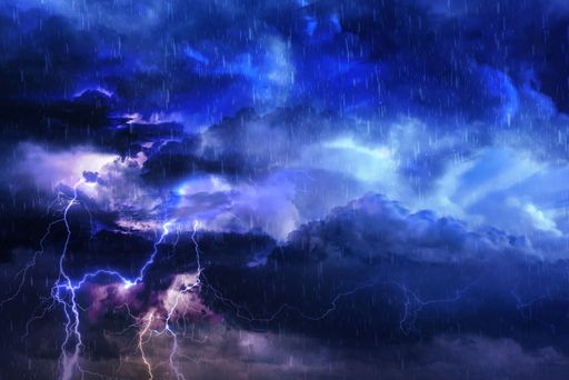 A dramatic cloudy sky with flashes and rain