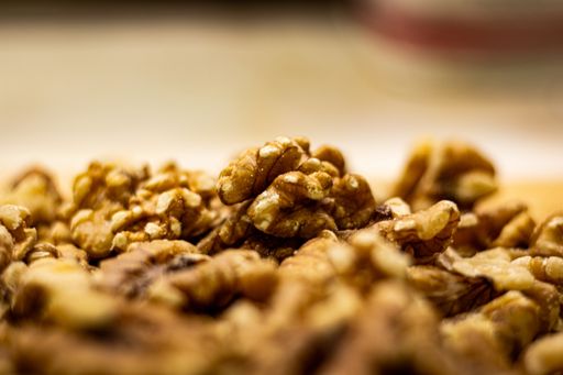 A selective focus shot of a walnut on top of a pile with a blurred background