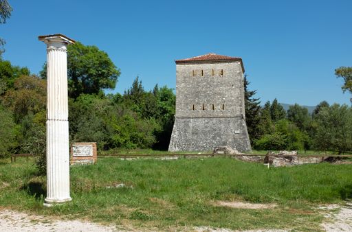 A roman column and Venetian tower at Butrint archaeological site, in Albania