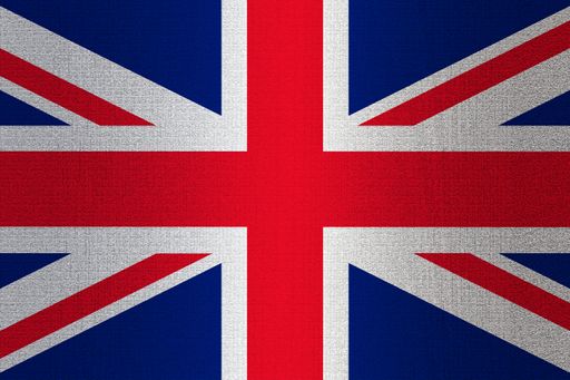 A flag of United Kingdom on a stone wall background.