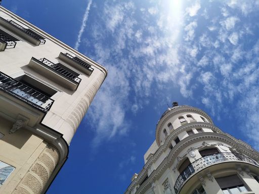 A low angle shot of beautiful buildings under a blue sky in Madrid, Spain