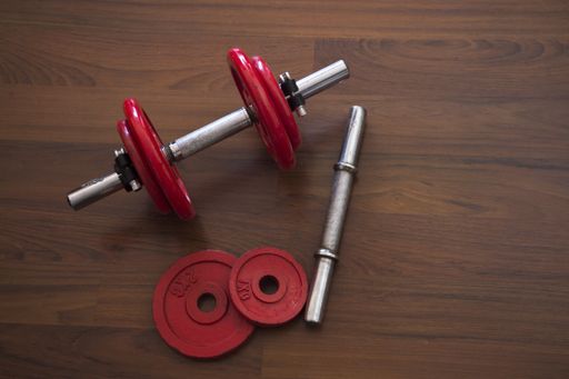 A high angle shot of dumbbells on a wooden surface