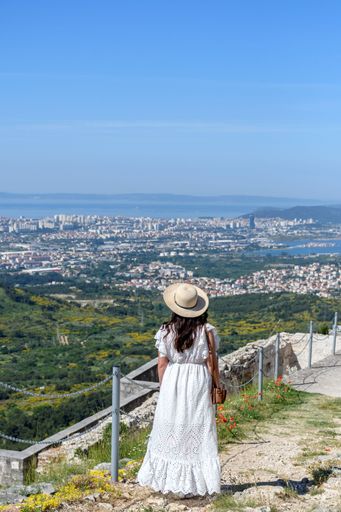 A Caucasian Woman looking at amazing view of city of Split in Croatia from Klis fortress