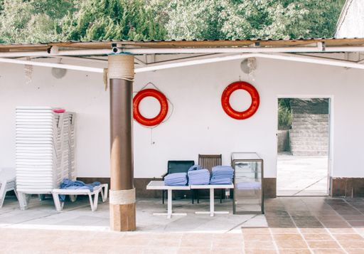 Red lifesavers at a swimming area with a low roof