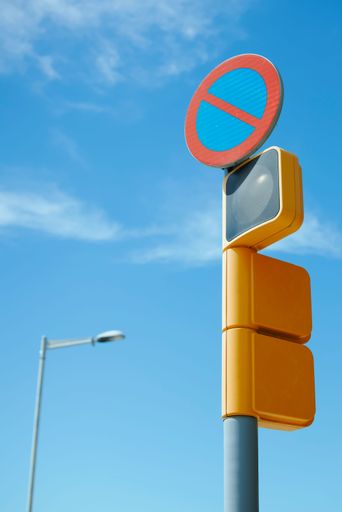 A vertical shot of a traffic light and a sign