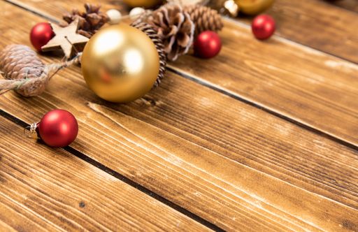 The red christmas balls with silver confetti trees on a wooden table