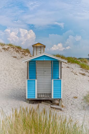 A vertical shot of small huts at the beach in Skanor, Skane County, Sweden