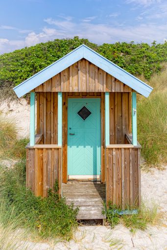 A vertical shot of small huts at the beach in Skanor, Skane County, Sweden