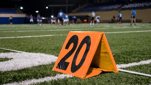 An American football gear in a field during a Flagfootball match at night