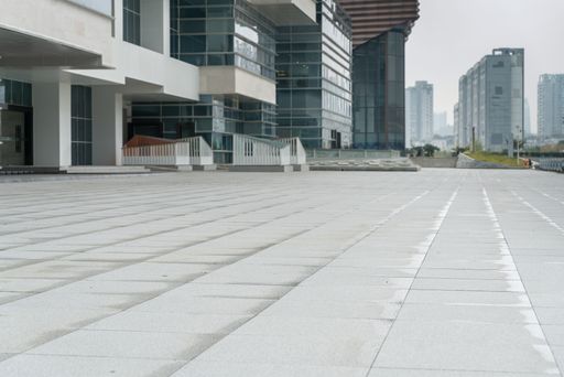 empty concrete floor with modern cityscape and office buildings. empty ground for car advertisement.