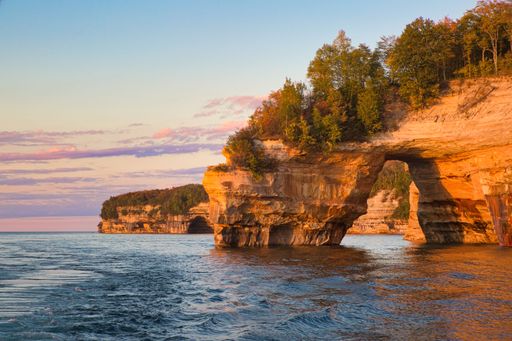 The Lover's Leap Arch in Pictured Rocks National Lakeshore against scenic sunset