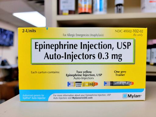 A closeup of double pack epinephrine medication on pharmacy table on blur background