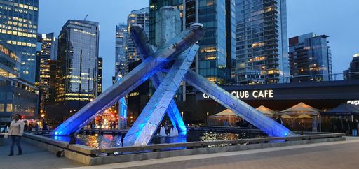 An illuminated cityscape view with the Olympic cauldron in Vancouver at Convention Centre