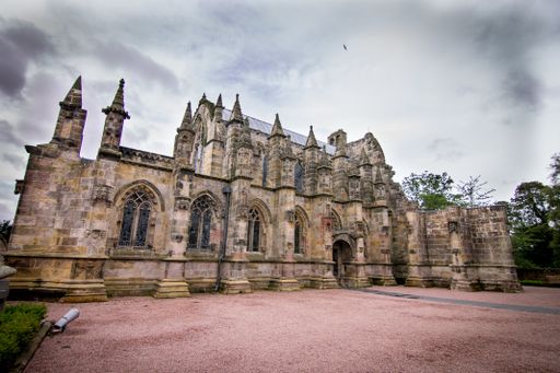 A breathtaking view of the facade of the magnificent Roslin Chapel captured on a cloudy day in UK