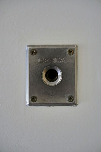A vertical shot of a Gerda brand security lock on an entrance door