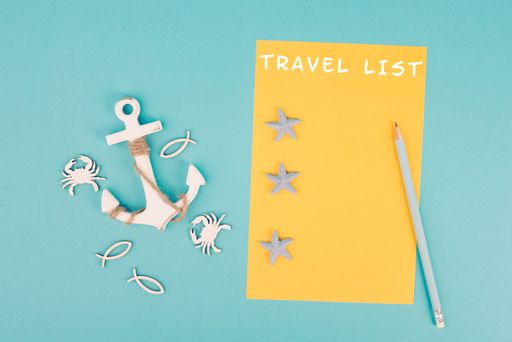 Travel list is standing on the yellow colored paper, anchor with fish sea stars and crabs, holiday plan and destination, vacation and lifestyle concep