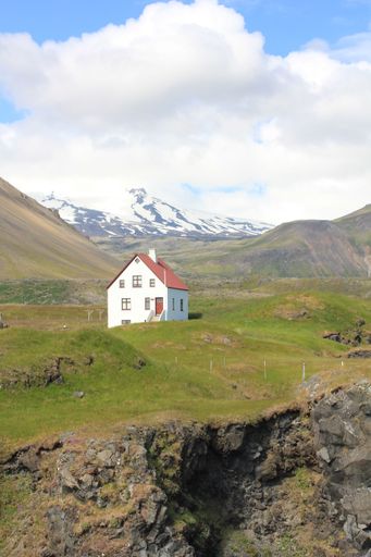 Scenic Icelandic landscape with white house on Snaefellsnes (vertical), Arnarstapi, Iceland