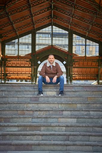 A vertical shot of a young male sitting at the staircase in Montreux, Switzerland