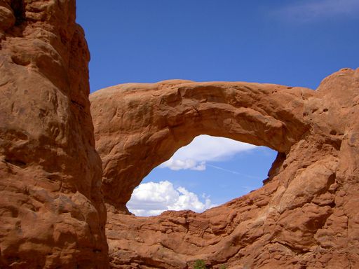 A closeup of South Window Arch against blue sky with clouds in the Arches National Park, Utah, USA