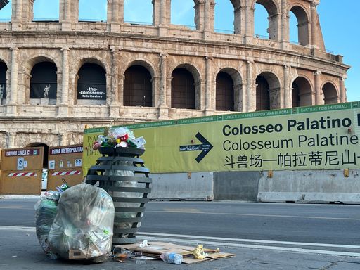 Bags of garbage in and next to the trash can at the Colosseum in the Italian capital of Rome