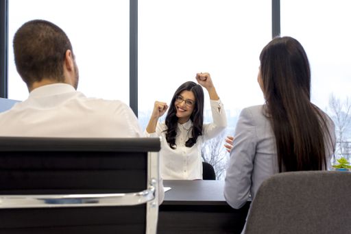 A positive satisfied young businesswoman at the office during the meeting