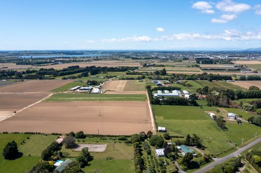 Aerial shot of Ohau village in the Horowhenua region of New Zealand with flat fertile farmland, lifestyle housing. Looking north to Levin