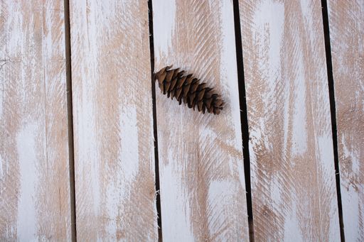 An overhead shot of a pine on a wooden surface - perfect for background