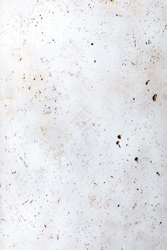 A vertical shot of a white concrete surface with grunge and copy space
