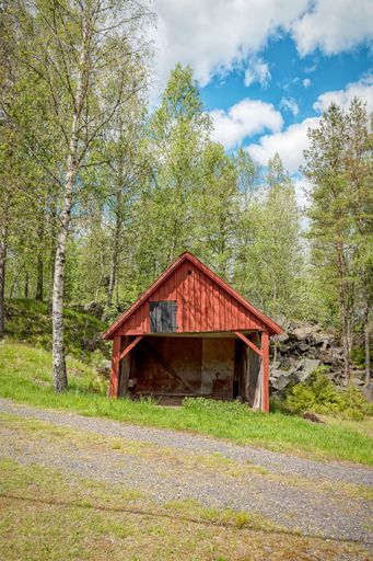 A vertical shot of an old wooden barn at the Black Mountains open-air museum in Traneboda, Sweden