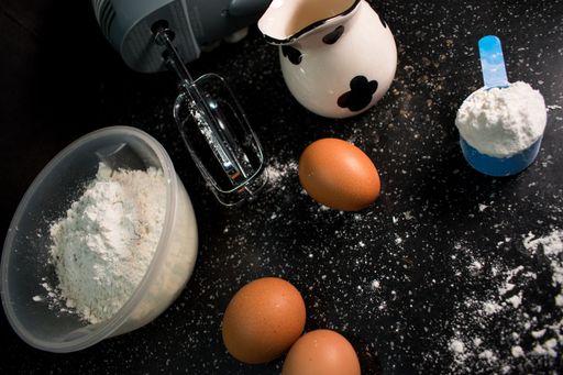 A view of flour and eggs on a kitchen table prepared for baking something delicious