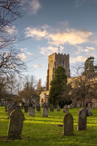 St Neots, UK - December 31st 2021: St Mary's Church tower and grave yard. High Quality Image