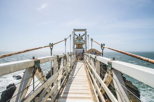 A beautiful shot of Point Bonita Lighthouse against blue sky in bright sunlight in Marin County, California, United States
