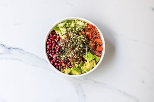 The top view of a bowl of healthy salad with veggies