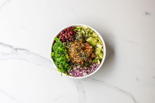 The top view of a bowl of poke -healthy salad with veggies