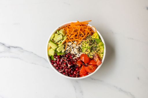 The top view of a bowl of healthy salad with veggies