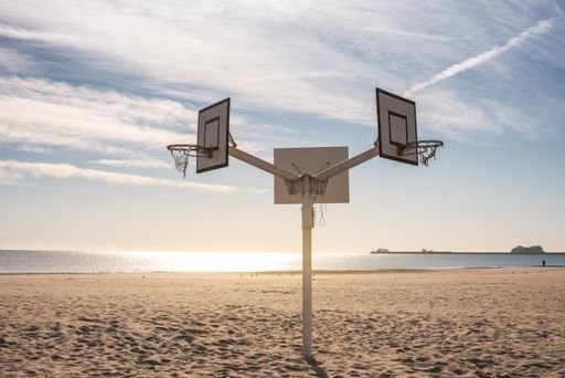 The view of double-sided basketball hoop on the sand of the beach