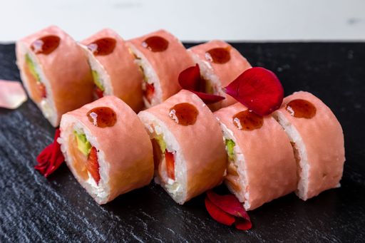 Eight pieces of sushi rolls on a black wooden board