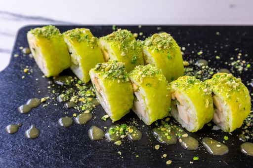 Eight pieces of sushi rolls on a black wooden board