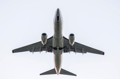 Embraer 190 arliner taking off from below.