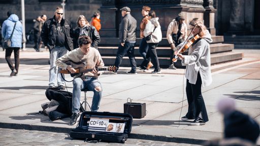 Street musicians playing guitar and violin in Dresden, Germany