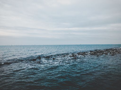 A horizontal shot of beautiful sea waves under the cloudy sky - great for a perfect background