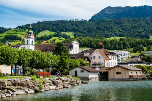 A scenic view of houses of Kussnacht village on the background of the mountain Rigi, Switzerland