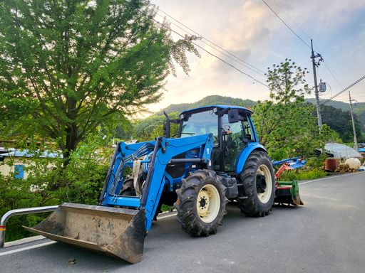 A blue tractor parked on the street