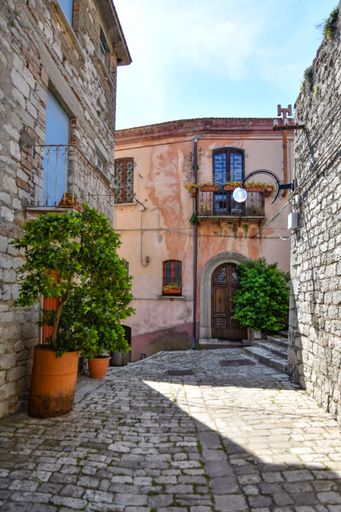 A narrow alley between medieval stone buildings in Morcone, Benevento, Italy