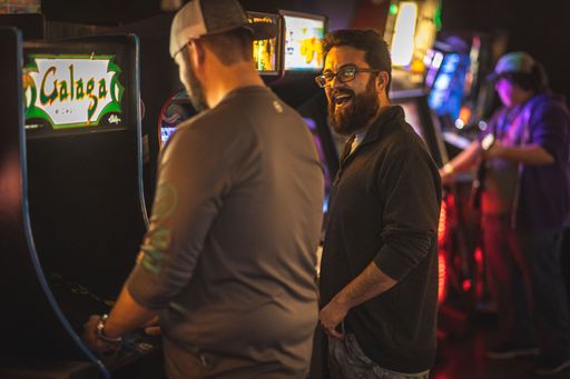 The patrons enjoying the arcade game offered by Fort Worth's local arcade bar