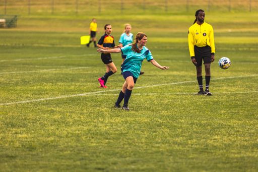 The young girls playing soccer at Youth Soccer Game