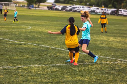 The young girls playing soccer at Youth Soccer Game