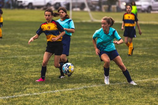 The young girls playing soccer at Youth Soccer Game